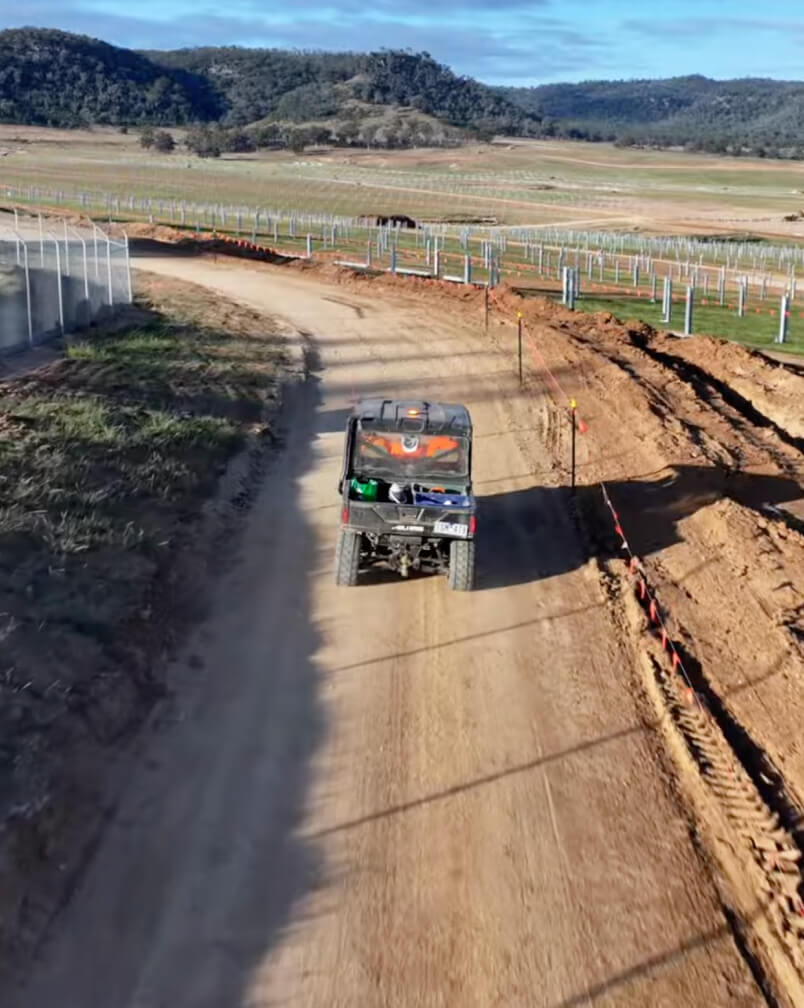 Tradeconnex workers transporting around site in an all terrain vehicle